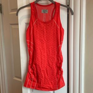 Bright coral Athleta tank top with reflective seams